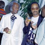 Camello "Frenchie" Casimer (L) and Bill Smith attend a party in honor of David Hockney, held in the New York City loft apartment of art dealer Michael Findlay on May 15, 1972. (Photo by Peter Simins/WWD/Penske Media via Getty Images)