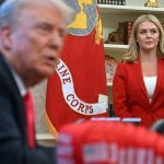 White House Press Secretary Karoline Leavitt (R) looks on as US President Donald Trump speaks to the press next to hats reading "Trump was right about everything", after signing an Executive Order at the Oval Office of the White House in Washington, DC on February 25, 2025. Trump signed an executive order on price transparency requirements on the health care industry to reinstate and strengthen them. He also signed an order on the supply of copper and foreign copper in the American market, the order charges Lutnick with looking at process to potentially impose tariffs or trade barriers.