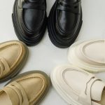 Women's leather stylish loafers on a white background, women's summer shoes close-up. Fashionable shoes for women. Selective focus