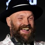 Boxer Tyson Fury speaks during a press conference in Riyadh, Saudi Arabia, Thursday, Dec. 19, 2024 ahead of the WBA, WBO, and WBC heavyweight title bout between Britain's Tyson Fury and Ukraine's Oleksandr Usyk. (AP Photo/Frank Augstein)