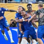 Chelsea's Christopher Nkunku is congratulated after scoring his teams second goal during the Club World Cup round of 16 soccer match between Benfica and Chelsea in Charlotte, N.C., Saturday, June 28, 2025. (AP Photo/Chris Carlson)