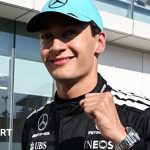Mercedes' George Russell clenches his left fist in celebration and smiles at the camera after taking pole position for the Canadian Grand Prix