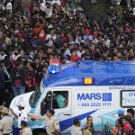 An ambulance arrives at the M. Chinnaswamy Stadium as fans gather to celebrate Royal Challengers Bengaluru cricketers, winners of the Indian Premier League, in Bengaluru, India, Wednesday, June 4, 2025. (AP Photo/Aijaz Rahi)