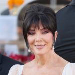 Kris Jenner styles a twisted updo, inspired by Audrey Hepburn and the early '60s, for the Bezos-Sánchez wedding.