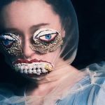 The artist Alisa Gorshenina wearing artificial eyes and a jeweled mouth.