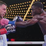 Richardson Hitchins, right, punches Australia's George Kambosos Jr. during the third round of a welterweight title boxing match Saturday, June 14, 2025, in New York. (AP Photo/Frank Franklin II)