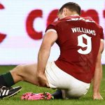 Tomos Williams of the British & Irish Lions is attended to by a trainer as he grabs his hamstring after scoring a try against Western Force