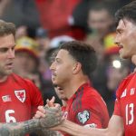 Wales' defender Joe Rodon celebrates with teammates after scoring the first goal during the match between Wales and Liechtenstein