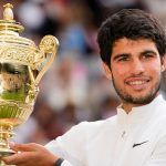 Spain's Carlos Alcaraz celebrates with the trophy after beating Serbia's Novak Djokovic to win the final of the men's singles on day fourteen of the Wimbledon tennis championships in London, Sunday, July 16, 2023. (AP Photo/Kirsty Wigglesworth)