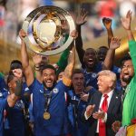 USA President Donald Trump looks on as Chelsea captain Reece James lifts the Club World Cup
