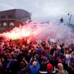 Crystal Palace fans protest with flares and banners at Selhurst Park after being demoted by UEFA to the Conference League