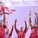 Diogo Jota lifts the Premier League trophy amid Liverpool's celebrations at the end of the 2024/25 season