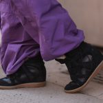 Isabel Marant's sneaker with hidden wedge seen in Vienna in 2025.