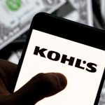 In this photo illustration the American department store retailing chain company Kohl's logo seen displayed on a smartphone with USD (United States dollar) currency in the background.