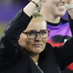 Sarina Wiegman applauds the fans after England's win against Sweden