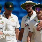 Australia's Mitchell Starc embraces captain Pat Cummins, right, after defeating West Indies