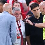 Referee Anthony Taylor speaks to Bournemouth boss Andoni Iraola (left) and Arne Slot (right) after Antoine Semenyo reported racist abuse