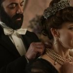Margan Spector and Carrie Coon in The Gilded Age, Season Three, on HBO Max. Coon is wearing pearl necklace, earrings and a crystal embellished tiara.