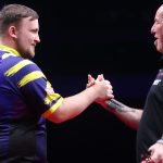 Luke Littler, left, and Mark Cleaver shake hands after the match (Credit: PDC)