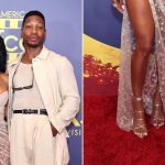 Meagan Good wears strappy silver metallic wrap stiletto sandals alongside Jonathan Majors at the 7th Annual AAFCA Awards on Saturday.