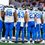 Players gather as the NFL preseason game between Detroit and Atlanta is  suspended following Morice Norris' injury