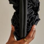 The crocheted rose clutch is handcrafted by Syrian refugee