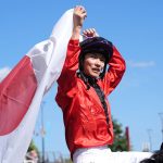 Ryusei Sakai proudly holds the Japanese flag aloft after victory at the Shergar Cup