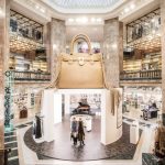 A Michael Kors pop-up at Galeries Lafayette Champs-Élysées in Paris features a giant handbag.