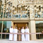 Ahmed Seddiqi family members stand at ribbon-cutting ceremony in front of new Riyadh flagship boutique with geometric patterned facade and brand signage