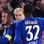 Chelsea players celebrate their opening goal against Benfica, an own goal scored by Richard Rios