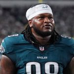 Philadelphia Eagles defensive tackle Jalen Carter walks off the field after being disqualified for spitting on Dak Prescott