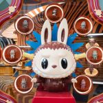 A Labubu surrounded by lit shelves holding miniature versions of the toy at Pop Mart's mega global landmark store at Iconsiam, Bangkok.