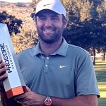 Scottie Scheffler holds the trophy after winning the Procore Championship