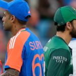 Pakistan captain Salman Agha, right, walks past India captain Suryakumar Yadav after the coin toss before thei Asia Cup group match