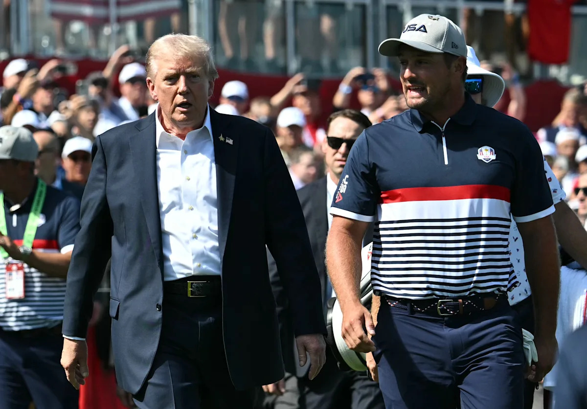 President Donald Trump greeted by cheers, boos and bows at Ryder Cup