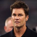 Tom Brady shown in Raiders booth wearing headset during MNF