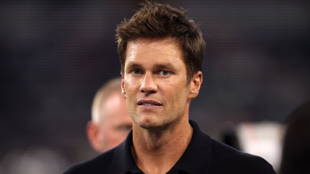 Tom Brady shown in Raiders booth wearing headset during MNF