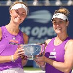 Erin Routliffe, of New Zealand, left, and Gabriela Dabrowski, of Canada, hold the championship trophy after defeating Taylor Townsend, of th