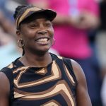 Venus Williams of the United States celebrates with partner Leylah Fernandez of Canada (not pictured) after defeating Shuai Zhang of China a