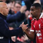 Liverpool boss Arne Slot shakes hands with striker Alexander Isak