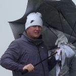 Robert MacIntyre shelters from the weather at the Alfred Dunhill Links