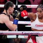 Puerto Rico's Amanda Serrano, right, punches Ireland's Katie Taylor during the second round of a super lightweight championship boxing match Friday, July 11, 2025, in New York. (AP Photo/Frank Franklin II)