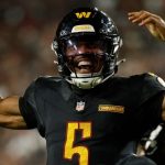 Washington Commanders quarterback Jayden Daniels (5) celebrates.