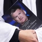 A member of clergy clutches a copy of the order of service before the service of thanksgiving for Ricky Hatton at Manchester Cathedral
