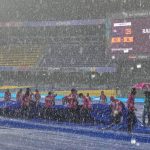 Groundstaff pull covers as it rains during the ICC Women's Cricket World Cup match between New Zealand and Sri Lanka in Colombo (AP Images)